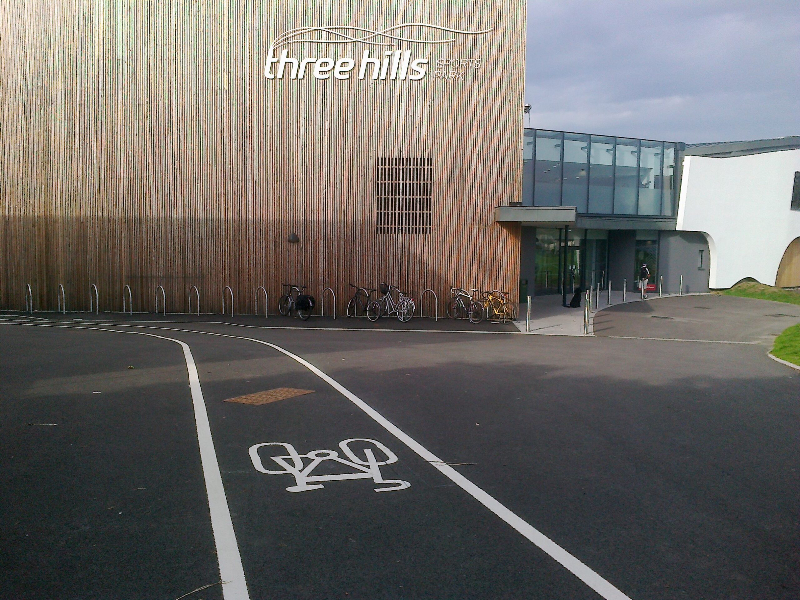 Cycle stands and stencilled cycle path at Three Hills Sports Centre 1